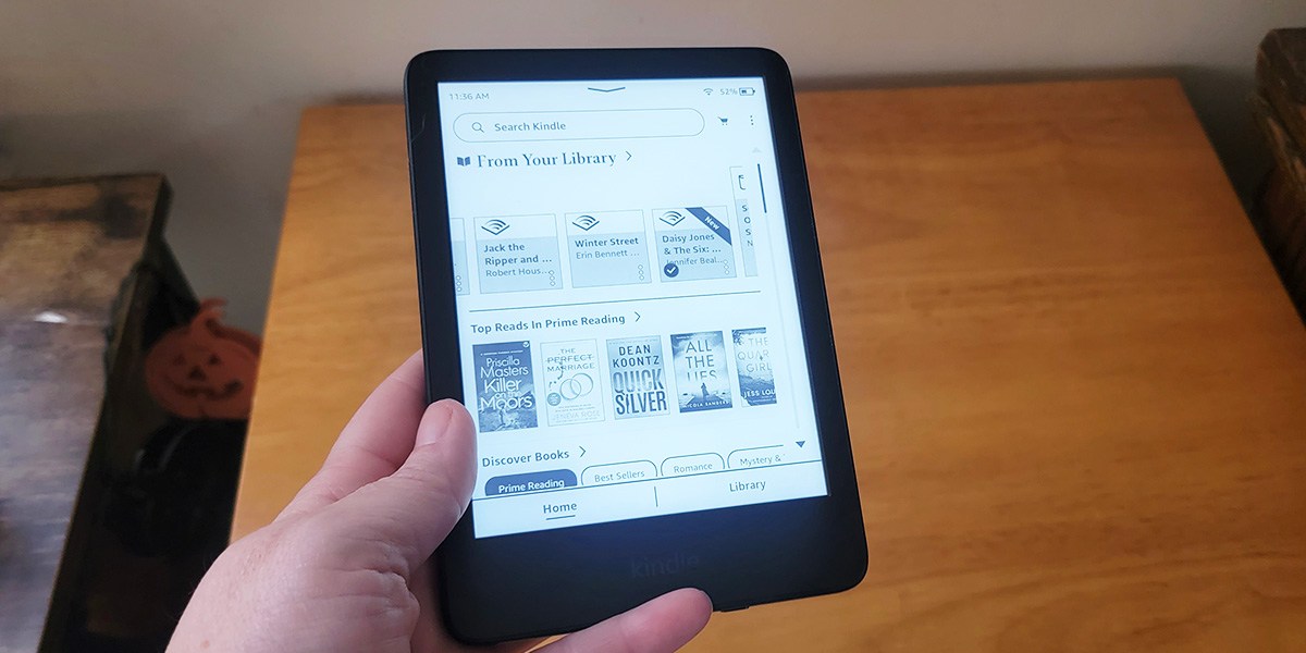 Hand holding Kindle Hand holding Kindle
