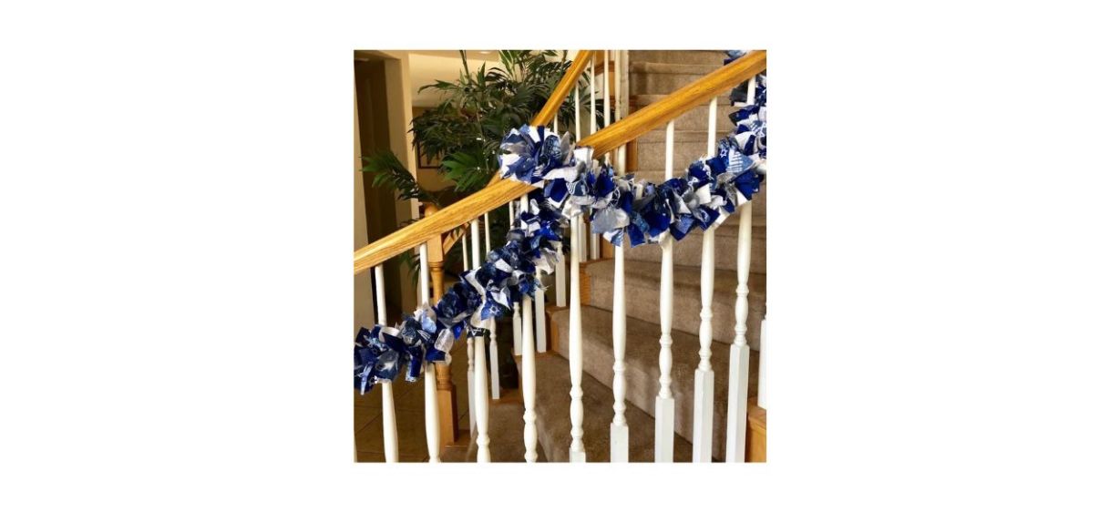 best 4allseasons Sparkling Hanukkah Garland, made of blue and white fabric strips with Hanukkah-based designs, on a stair banister