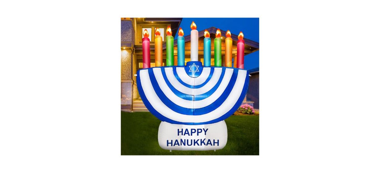 Turnmeon 6-foot inflatable Hanukkah Menorah Decoration With LED Lights with a sign that says "Happy Hanukkah"
