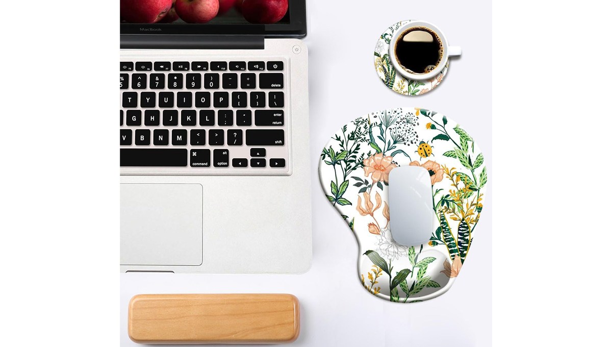 A DOOKE Ergonomic Mouse Pad sits on a table with a laptop, cup of coffee and laptop wrist pad. A DOOKE Ergonomic Mouse Pad sits on a table with a laptop, cup of coffee and laptop wrist pad.