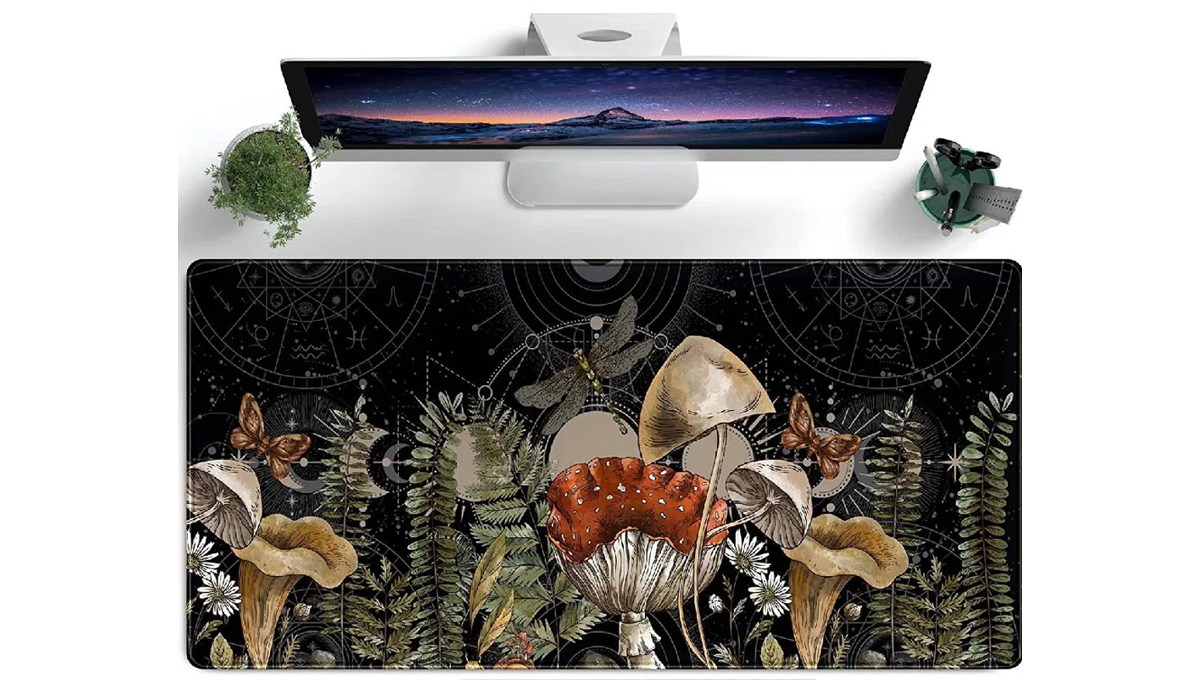 The East Urban Home Lycra Desk Pad is placed on a desk in front of a desktop monitor, a plant and a cup with writing utensils and tools in it. The East Urban Home Lycra Desk Pad is placed on a desk in front of a desktop monitor, a plant and a cup with writing utensils and tools in it.