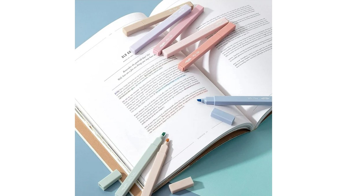 Eight Mr. Pen Aesthetic Pastel Highlighters of different colors placed on an open book. Eight Mr. Pen Aesthetic Pastel Highlighters of different colors placed on an open book.