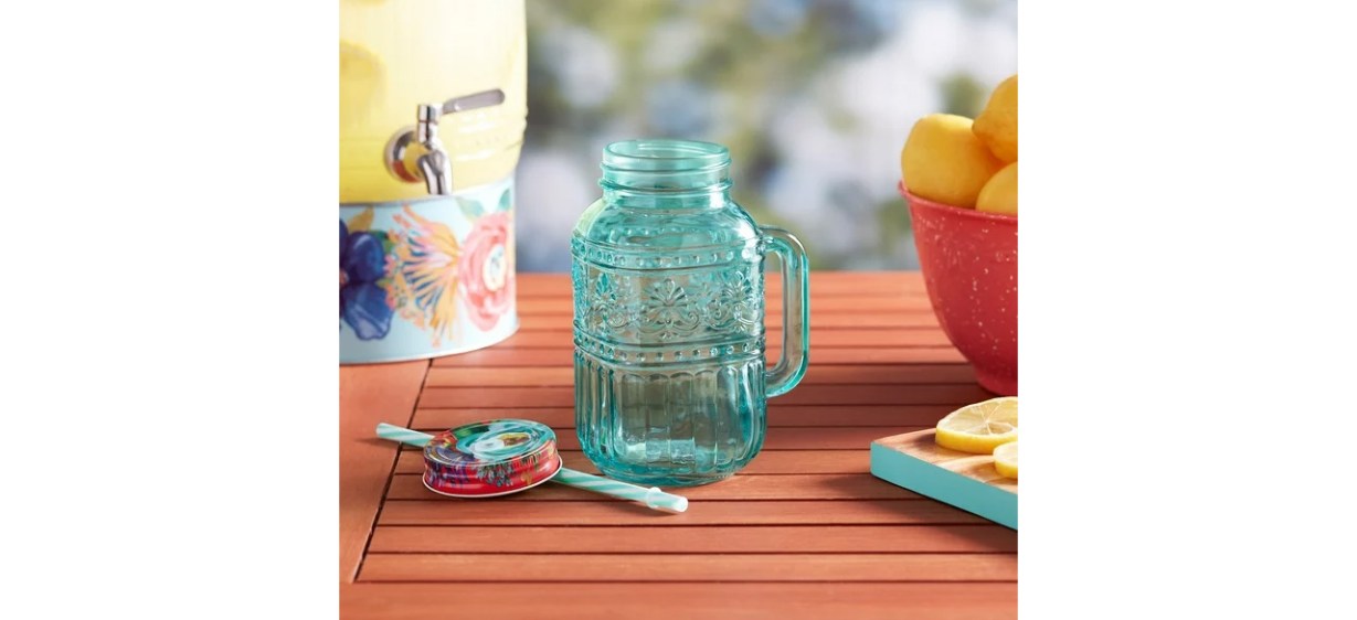 The Pioneer Woman Cassie 32-Fluid-Ounce Mason Jar Tumbler, Teal on table The Pioneer Woman Cassie 32-Fluid-Ounce Mason Jar Tumbler, Teal on table